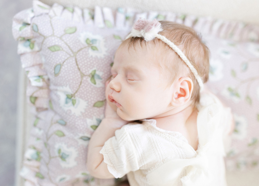 Alexandria VA newborn photographer captures a baby girl laying on her pillow sleeping
