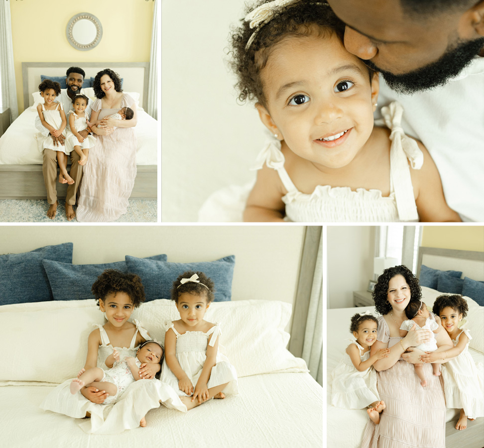 A happy family with two young sisters in white dresses, a newborn baby, and loving parents, sharing sweet moments together in a cozy, light-filled bedroom.