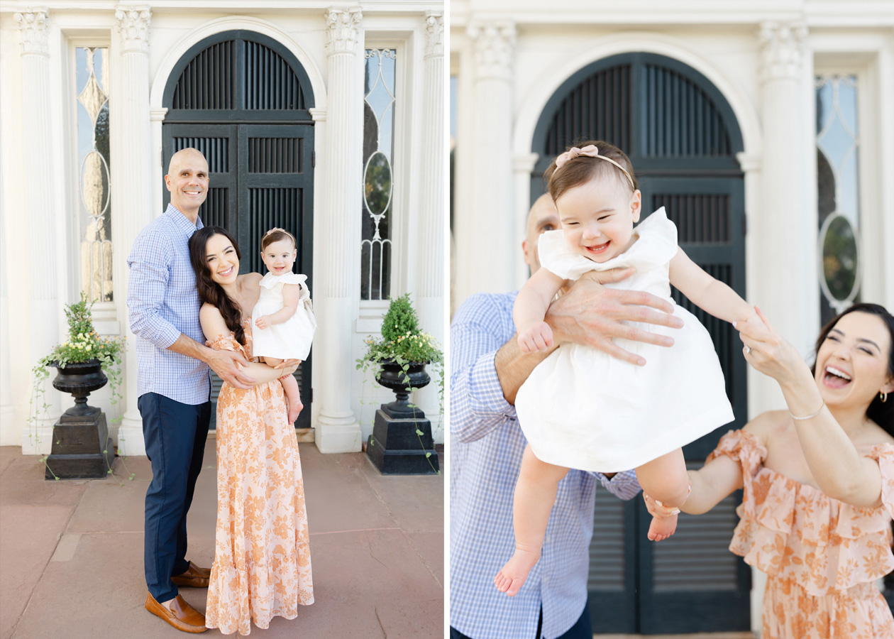 A smiling family of three poses in front of the Oatlands Historic House; the mother wears a peach floral dress while holding their baby girl in a white dress and bow headband. In the second image, the baby giggles joyfully as her father lifts her into the air, with her mother reaching out and laughing beside them.