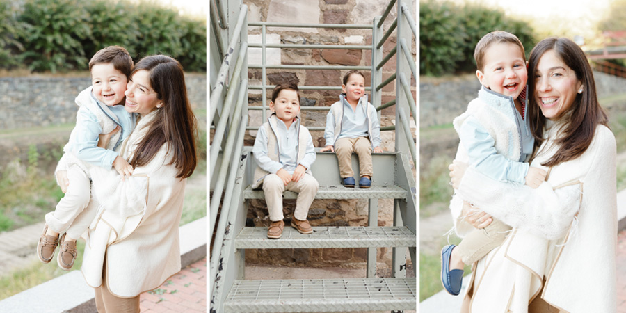 A mother and her young children smile and cuddle outdoors on a chilly day, capturing sweet moments. The kids sit and play on outdoor steps in cozy neutral outfits, enjoying simple seasonal fun together.