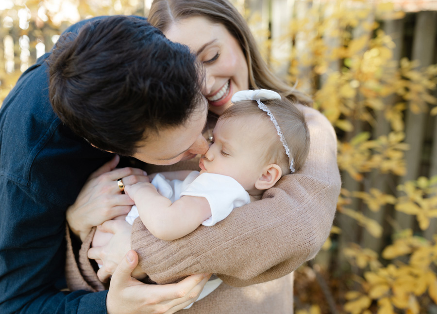 Fall outdoor milestone photography session in Alexandria, Virginia with dad kissing child on nose.