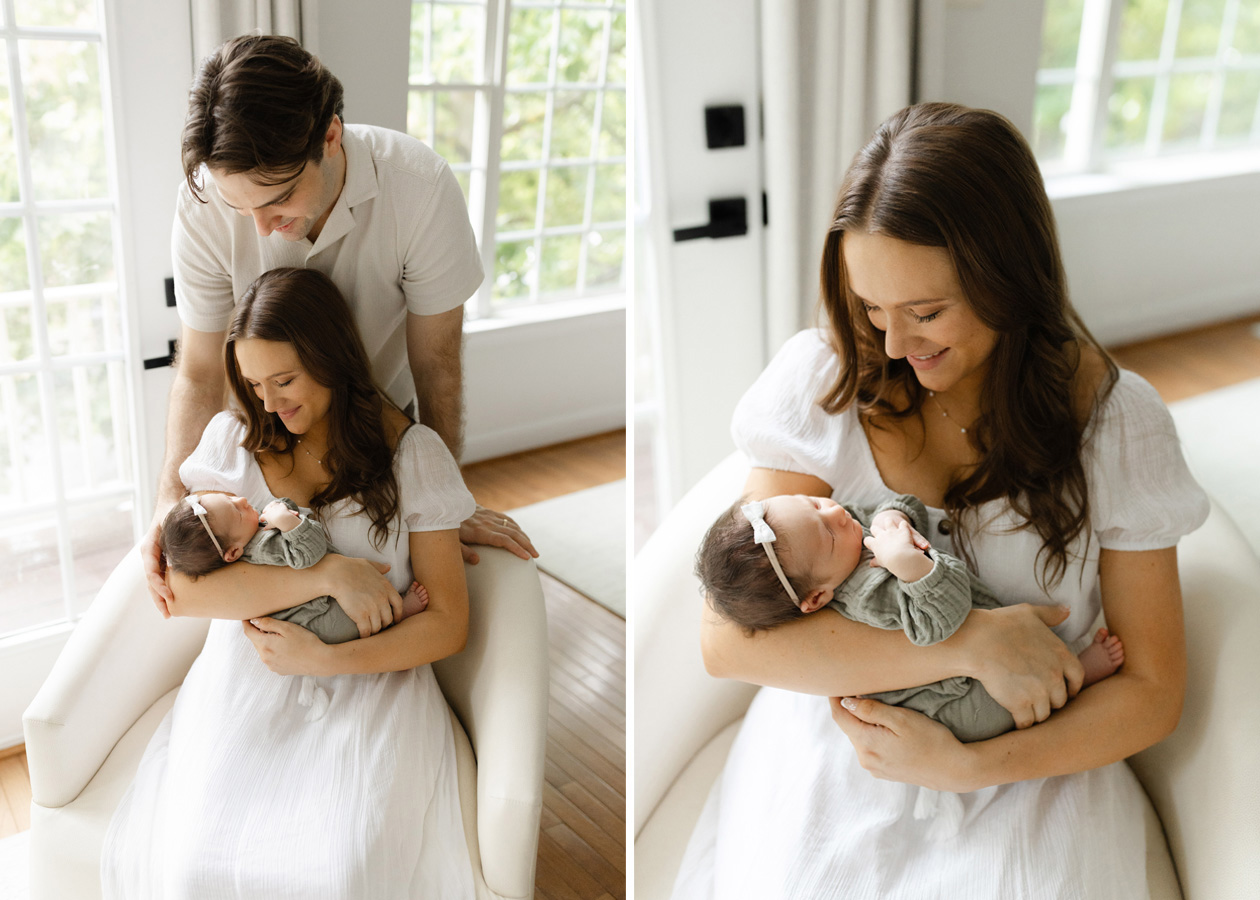 In-home newborn photography in Northern Virginia featuring a mother holding her newborn baby while dad stands close behind in their light-filled home.